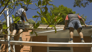 Tradesmen working on a roof with scaffolding